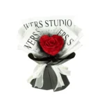 Round black box with a clear lid showcasing 9 preserved red roses in a tight, elegant arrangement