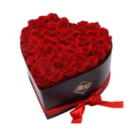 Heart-shaped keepsake box filled with 50 vibrant, preserved red roses arranged in a perfect heart formation 179.95