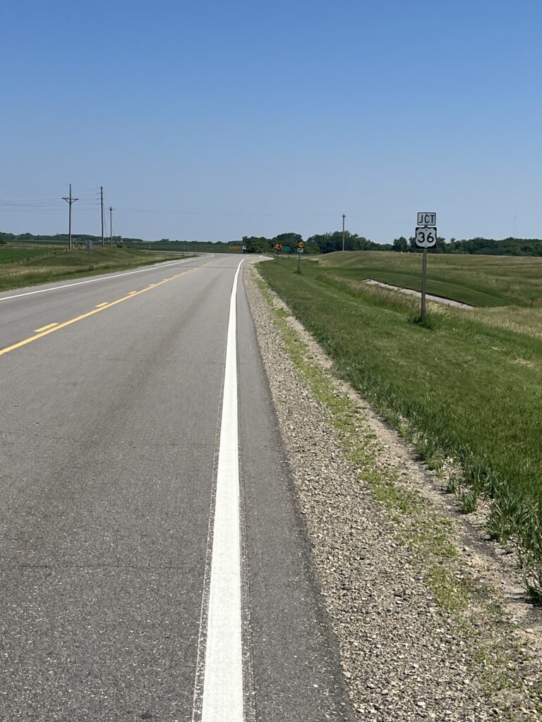 Sun-drenched Kansas countryside showcasing vast fields, distant horizons, and the timeless beauty of the heartland.