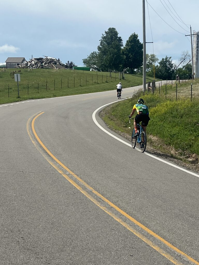 A winding road curving through the countryside, leading off into the distanc