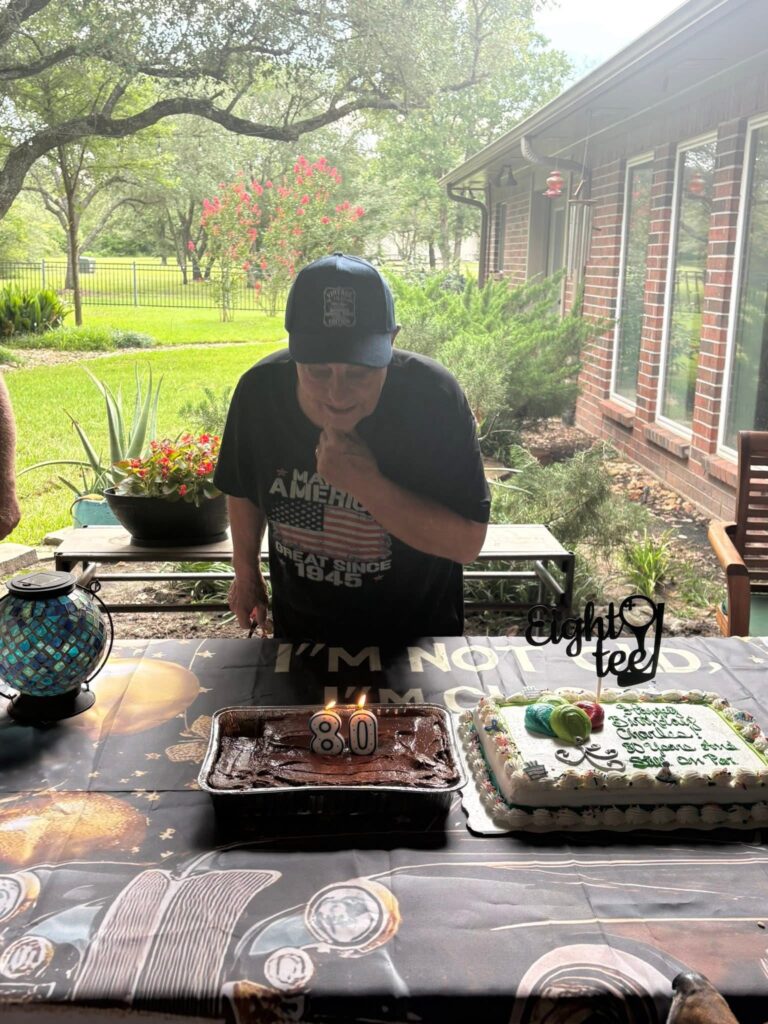Charles blowing out his 80th birthday candles, surrounded by family in Bryan, Texas – part of the ShauneNation July 2025 road trip.