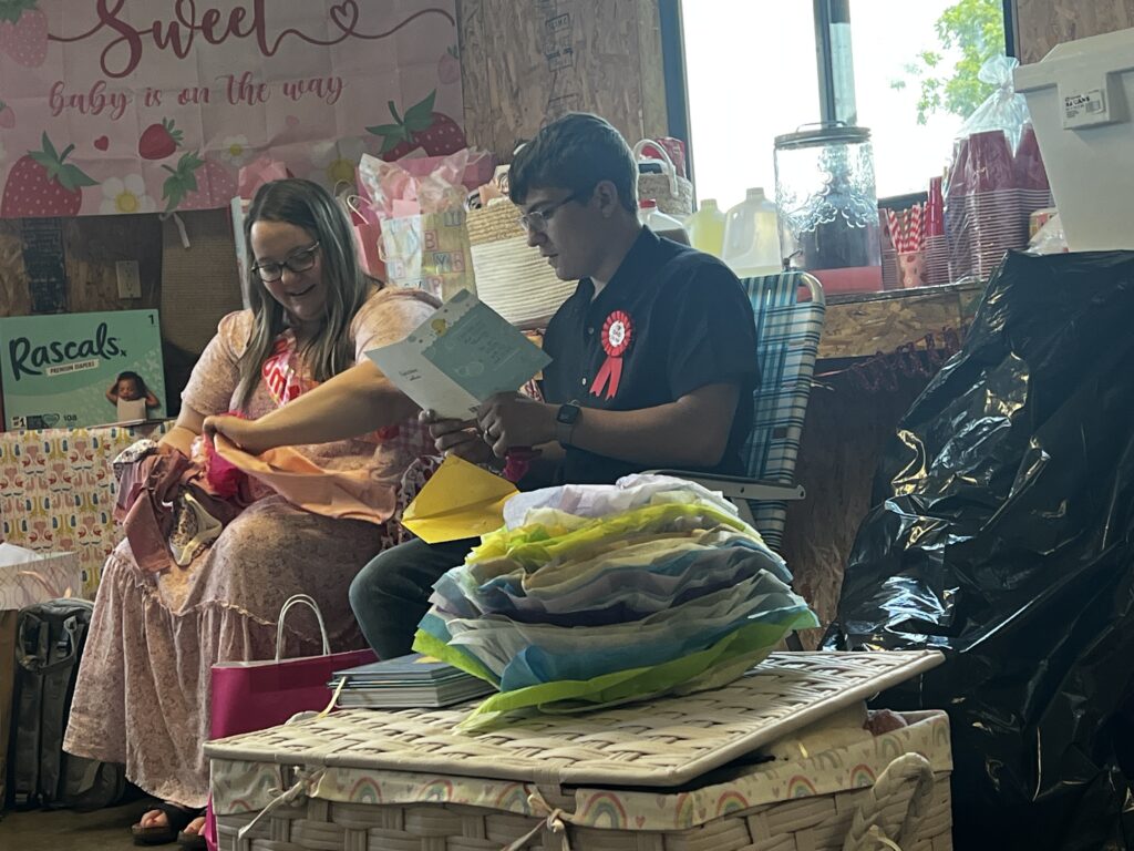 Brylan reading a heartfelt card at Baby Brinlee’s ShauneNation baby shower.