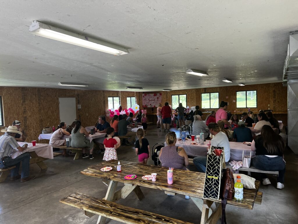 Group of family and friends smiling and celebrating together at Baby Brinlee’s baby shower.