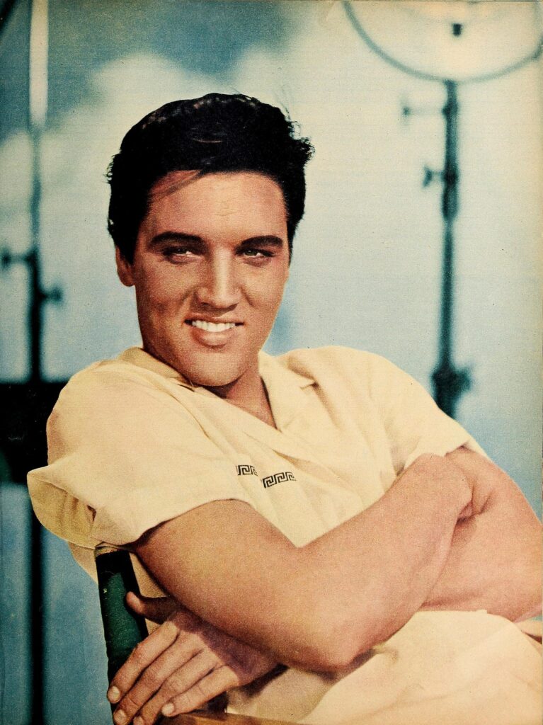 Elvis Presley smiling with arms folded during the 1968 Comeback Special