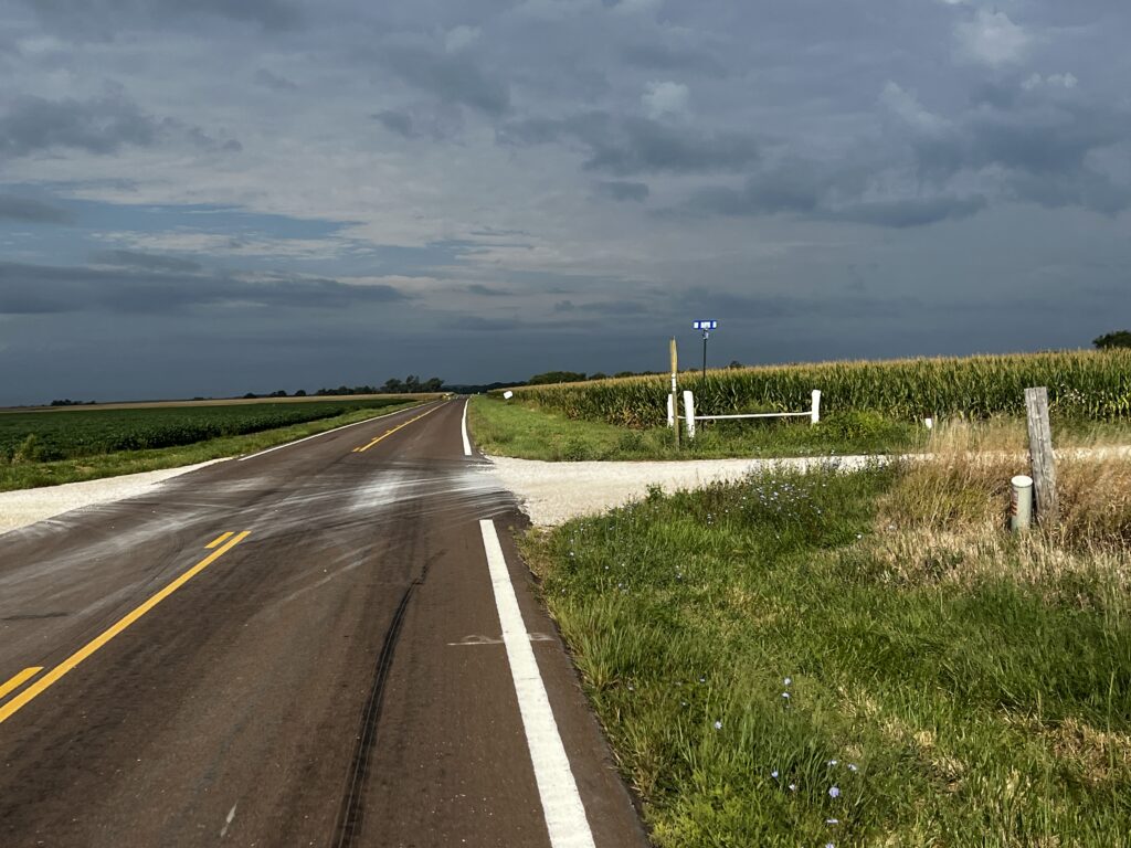 Scenic view of Kansas Highway 31 with open fields and a cloudy sky