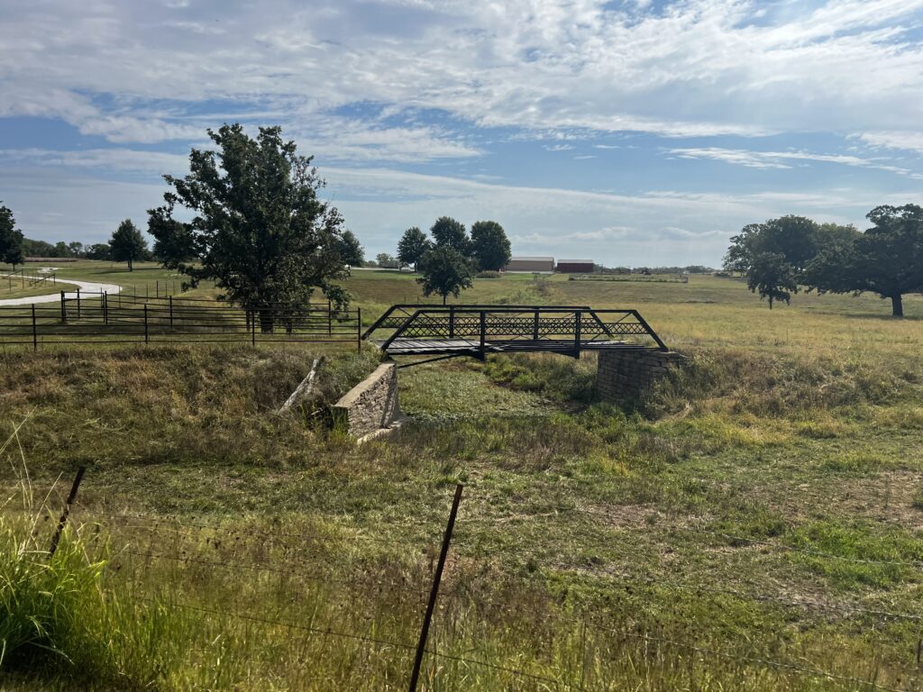 Old unused bridge on a farmer’s land between Sacred Heart Church and Williamsburg, Kansas, under cloudy skies.