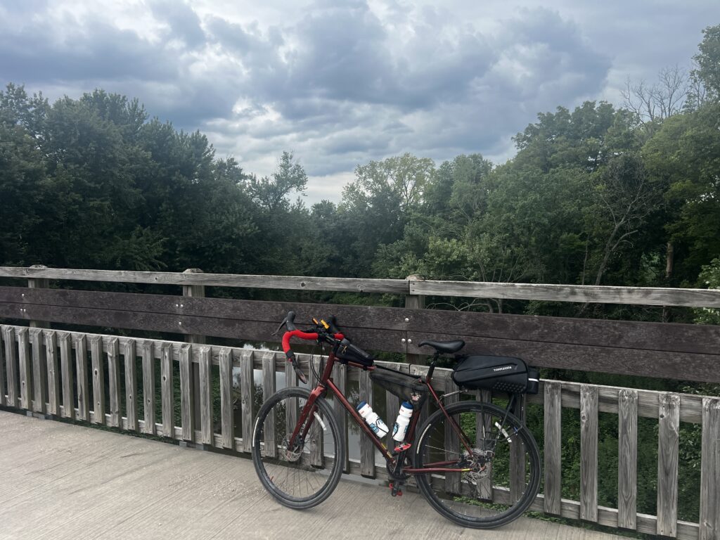 Bicycle parked on a wooden bridge over the Ponowanami River along the Prairie Spirit Trail