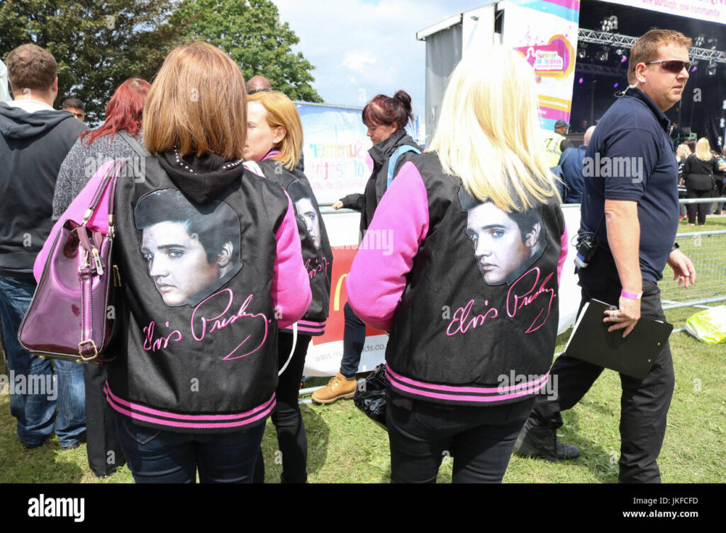 Fans at Graceland wearing Elvis Presley leather jackets, featuring pictures of Elvis on the back.