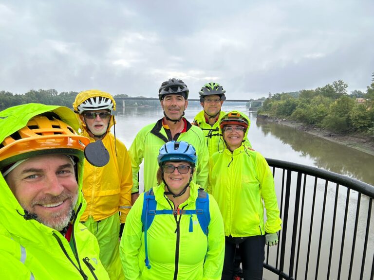 Cyclists crossing the lift bridge at Boonville on the Katy Trail, with the Missouri River in the background.