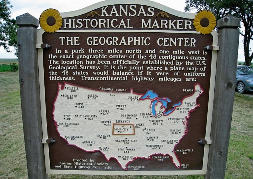 Kansas Historical Marker billboard showing a map of the United States and the Geographical Center near Lebanon, Kansas, visited by Shaune and riding partner during a Bike Across Kansas detour.