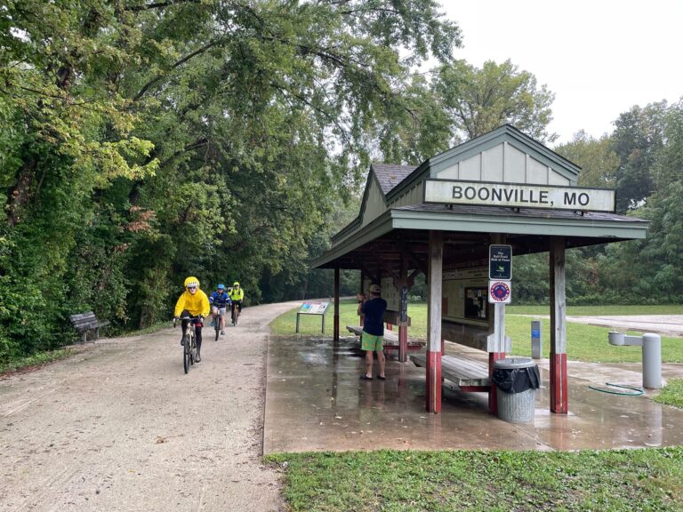 Cyclists arriving at Boonville Trailhead on the Katy Trail, soaked from rain and wet conditions.