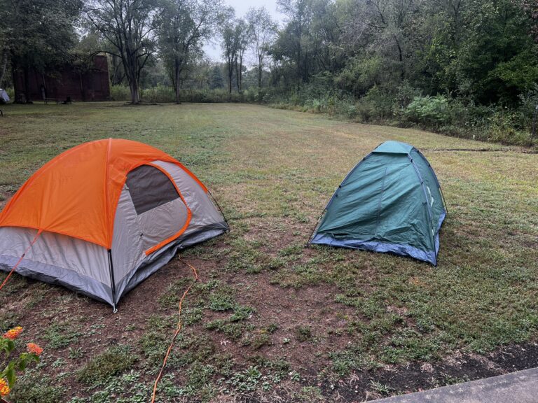 Two cyclists, me and Robert, camping in tents at Katy Roundhouse, New Franklin, MO, in rainy conditions.