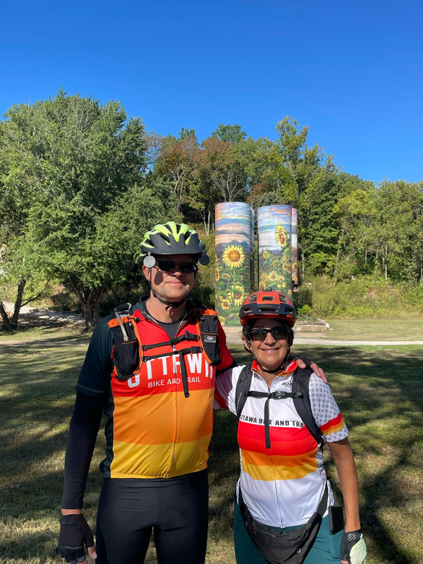 Dave and Kara with the vibrant sunflower murals on the silos at Sunflower Hill Farm, Augusta, Missouri.