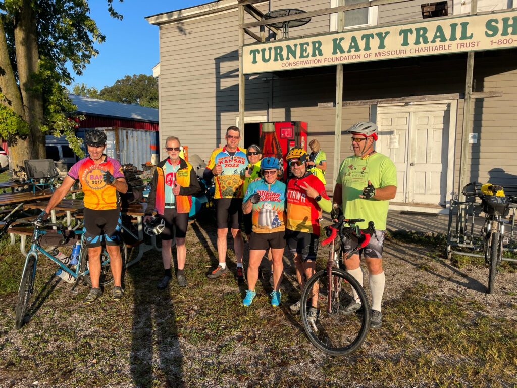 Group of cyclists in front of the Turner Katy Trail Shelter in Tebbetts, Missouri with bikes ready for the day