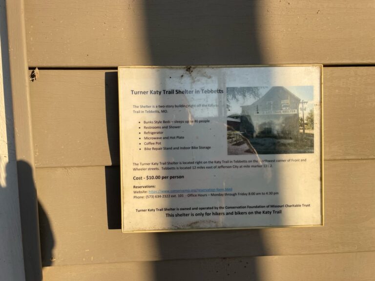Informational shadow box at the Turner Katy Trail Shelter in Tebbetts, Missouri showing payment details and hostel info