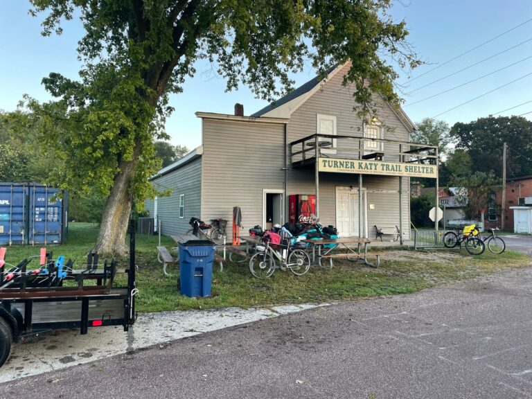 Exterior of the Turner Katy Trail Shelter hostel in Tebbetts, Missouri with bicycles parked outside