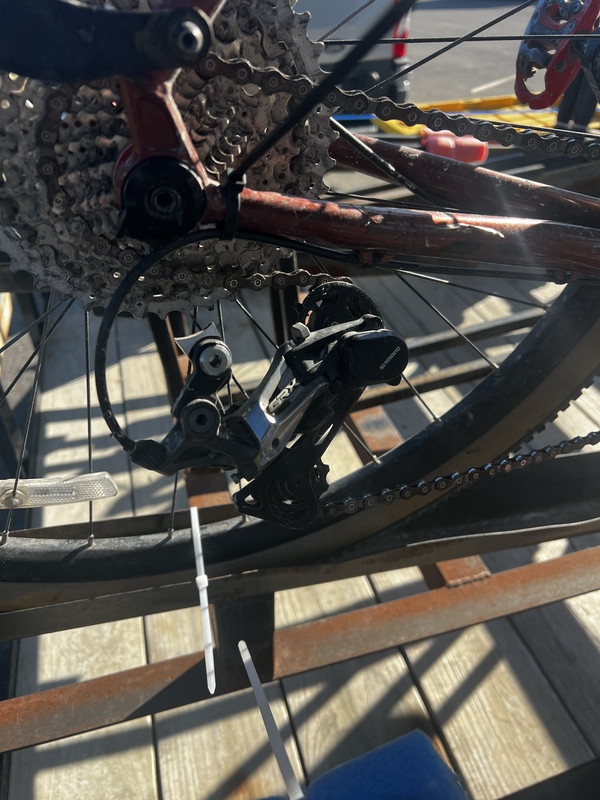 Bicycle leaned against a pole at Marthasville, Missouri, showing a broken derailleur after tipping over, captured on a ShauneNation ride