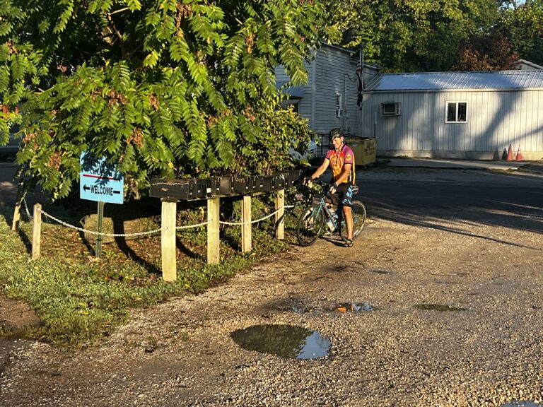 Rob, a mailman, on his bicycle in front of five mailboxes in Tebbetts, Missouri along the Katy Trail