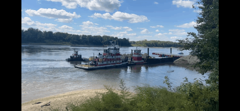 Tugboat pushing barges loaded with rocks to build in-water levees, captured on a ShauneNation Missouri bike ride