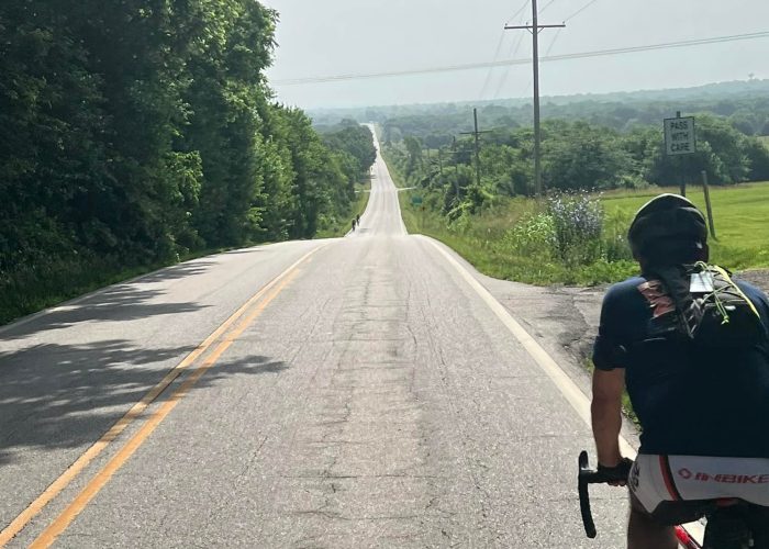 Cyclist Rob riding into the gentle rolling hills of Kansas on the final day of Bike Across Kansas.